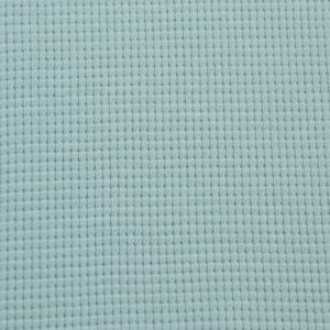 May include: A close-up of a light blue waffle knit fabric. The fabric has a textured, waffle-like pattern.
