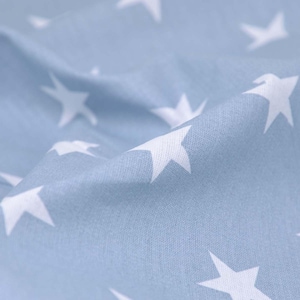May include: A light blue fabric with a white star pattern. The fabric is soft and has a subtle texture.