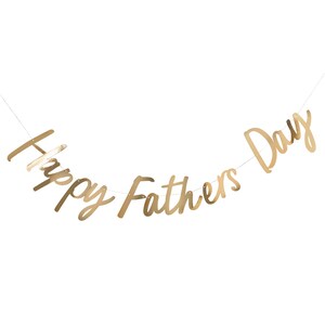 May include: Gold foil banner with the text "Happy Fathers Day" hanging on a white background.
