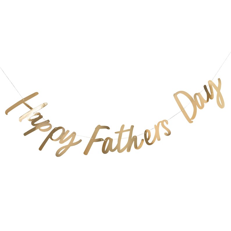May include: Gold foil banner with the text "Happy Fathers Day" hanging on a white background.