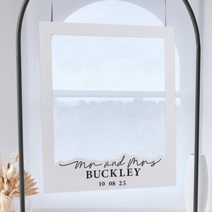 May include: White frame with a white background and black text that reads "Mr. and Mrs. BUCKLEY 10 08 25".