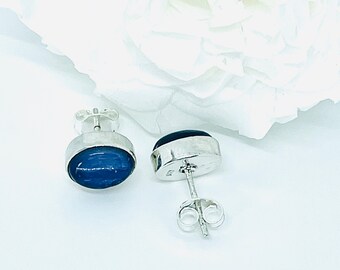 May include: A pair of silver stud earrings with oval-shaped blue gemstones. The earrings have a simple design and are perfect for everyday wear.
