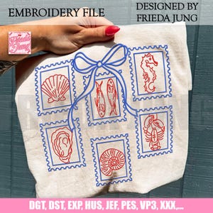 May include: An embroidery file design featuring a collection of red and blue postage stamp-style images of sea creatures, including a seashell, seahorse, and lobster. The design is on a beige fabric and includes the text "EMBROIDERY FILE" and "DESIGNED BY FRIEDA JUNG".