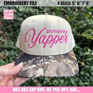 May include: A beige baseball cap with a camouflage brim. The cap features the embroidered text "professional Yapper" in pink script. The image also includes text that says "EMBROIDERY FILE" and "4 SIZES: 5" 6" 7" 8""