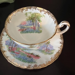 Gorgeous Vintage Aynsley Teacup and Saucer, Bluebell Time Pattern, beautiful scene of green trees, blue flowers, & pink and purple skies!