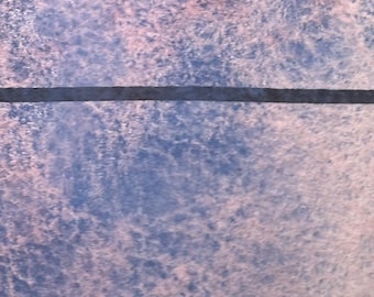 May include: A close-up of a textured surface with a horizontal black line across the middle. The surface is a mix of light blue and pink.