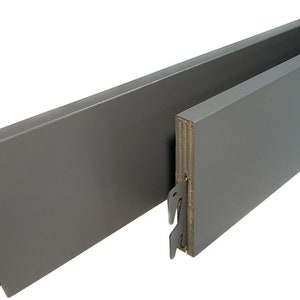May include: Two grey wooden bed rails with metal brackets. The rails are designed to fit under a mattress and prevent it from sliding off the bed frame.