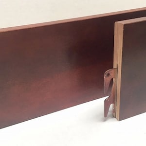 May include: Two wooden headboard panels with metal brackets. The panels are a dark reddish-brown color.