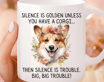 Może przedstawiać: Biały kubek ceramiczny z czarno-białym nadrukiem przedstawiającym corgi w koronie z kwiatów. Tekst na kubku brzmi "Silence is golden unless you have a corgi... Then silence is trouble. Big, big trouble!"