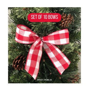 May include: Set of 10 red and white gingham bows. The bows are tied with a simple knot and have a wired edge. The bows are shown on a green Christmas tree.