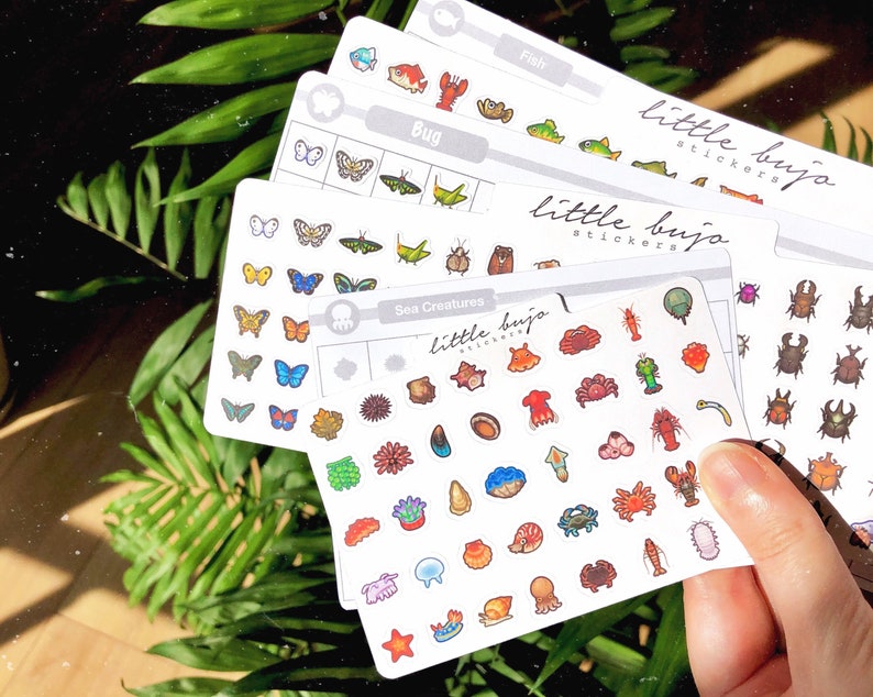 May include: Four sheets of stickers featuring various sea creatures, bugs, fish, and other animals. The stickers are on a white background with a grey border and the text "little bujo stickers" printed on each sheet.