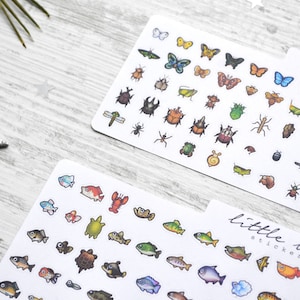 May include: Two sheets of stickers featuring illustrations of insects and fish. The insect sheet has a variety of colourful butterflies, beetles, and other bugs. The fish sheet has a variety of colourful fish, turtles, and a lobster. Both sheets have the text "little bujo stickers" printed on them.