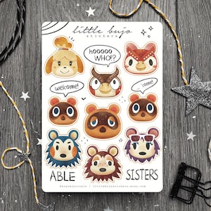 May include: A sheet of stickers featuring characters from the Animal Crossing video game series. The stickers are illustrated in a cartoon style and feature characters like Isabelle, Tom Nook, and the Able Sisters. The stickers are printed on white paper with a light brown background.