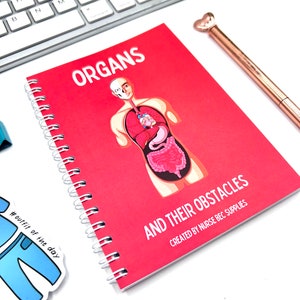 May include: A red spiral bound notebook with the title "ORGANS AND THEIR OBSTACLES" and a cartoon illustration of a human body with internal organs. The text "CREATED BY NURSE BEC SUPPLIES" is printed below the title.