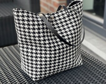 Houndstooth fabric bag closes with a magnetic clasp.