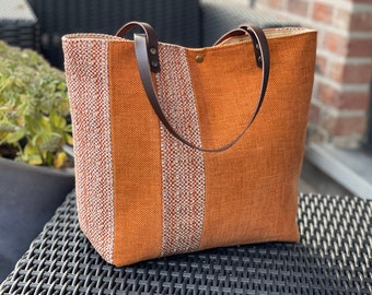 Patchwork shopping bag in orange tones, real leather handles and multiple pockets including one with zipper!