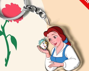 May include: A clear acrylic keychain featuring a cartoon illustration of a woman with brown hair wearing a blue and white dress, holding a small white teacup with blue bubbles. The keychain includes a silver metal ring and a chain attachment.