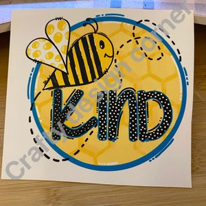 May include: A yellow and black bee with white polka dots on its wings is flying over a honeycomb pattern with the word "Kind" in black and white polka dots on a yellow background with a blue border.