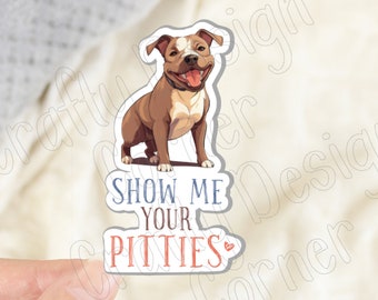 May include: A sticker featuring a cartoon pit bull dog with the text "Show Me Your Pitties" in blue and red lettering.