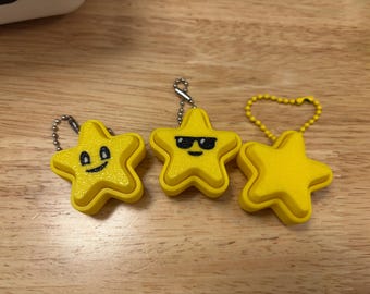 Fidget clicker a forma di stella, Fidget clicker a forma di stella, Portachiavi con faccina sorridente sul fidget clicker a forma di stella