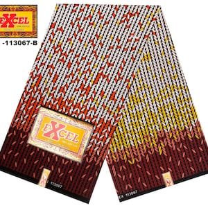 May include: A black and white fabric with a pattern of orange and yellow leaves. The fabric has the text "EXCEL 100% COTTON" on it. The fabric is labeled "EX-113067-B".