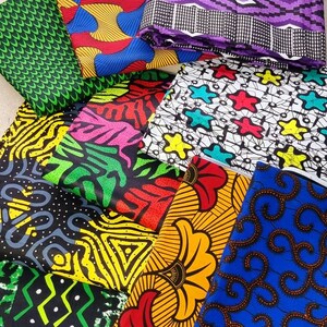 May include: A collection of colorful fabric scraps with various patterns, including geometric, floral, and abstract designs. The fabrics are in shades of red, yellow, blue, green, black, and white.