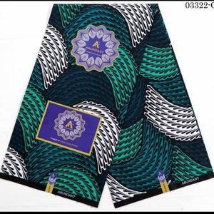 May include: A black and white fabric with a green and blue pattern of feathers. The fabric has the text "ABUNDANT" printed on it. The fabric is folded in half and the product code "03322-G" is printed in the top right corner.