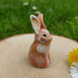 Miniature little red rabbit statuette