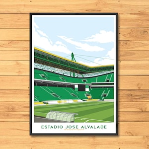 May include: A framed art print of the Estadio Jose Alvalade stadium, featuring a green and yellow color scheme. The stadium's architecture is depicted with a clear sky and clouds in the background. The text "ESTADIO JOSE ALVALADE" is at the bottom.