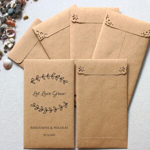 May include: Brown paper envelopes with a delicate lace-like design around the edges. The front of the envelope has the text "Let Love Grow" with a floral design and the names "Anastasiya & Nicolas" and the date "05.16.2020".