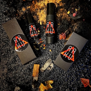 May include: Three black boxes with a red triangle and the text "RAKU" in white. The boxes are on a black surface with gold and red accents.