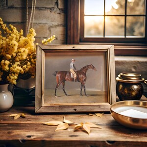 Wooden table with a framed horse painting, surrounded by a vase with yellow flowers, a golden candle holder, and autumn leaves by a sunlit window.