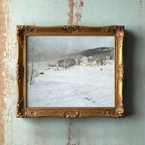 A framed painting of a snowy village landscape hangs on a weathered blue wall. The artwork depicts snow-covered houses and trees under a cloudy sky.