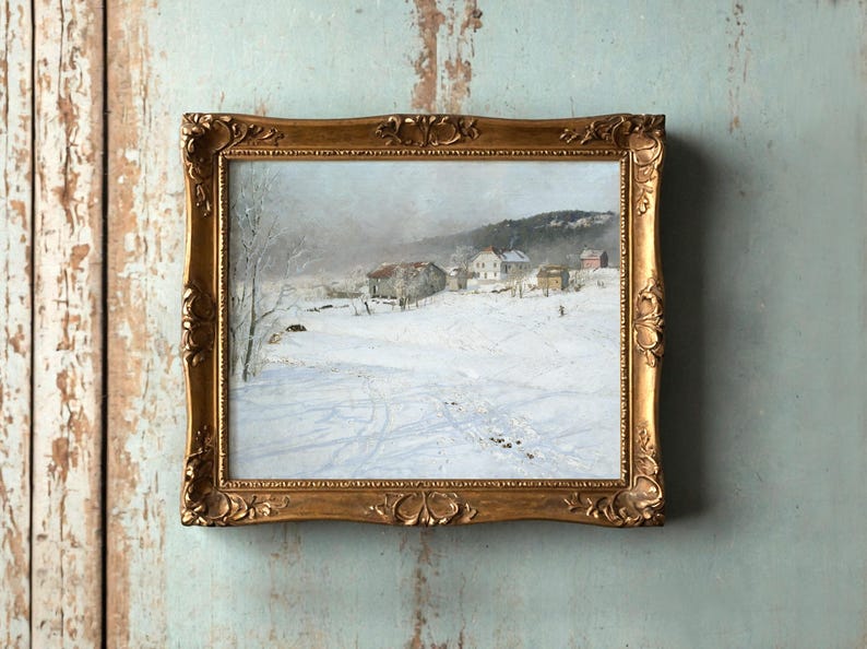 A framed painting of a snowy village landscape hangs on a weathered blue wall. The artwork depicts snow-covered houses and trees under a cloudy sky.