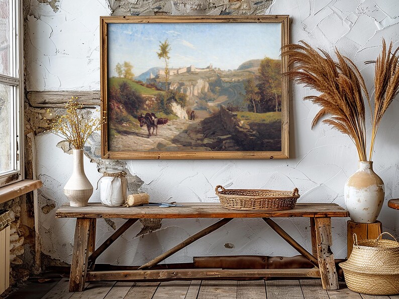 Rustic interior with a wooden bench, woven basket, and vases of dried grasses. A landscape painting in a wooden frame hangs on a textured wall. Warm, cozy ambiance.