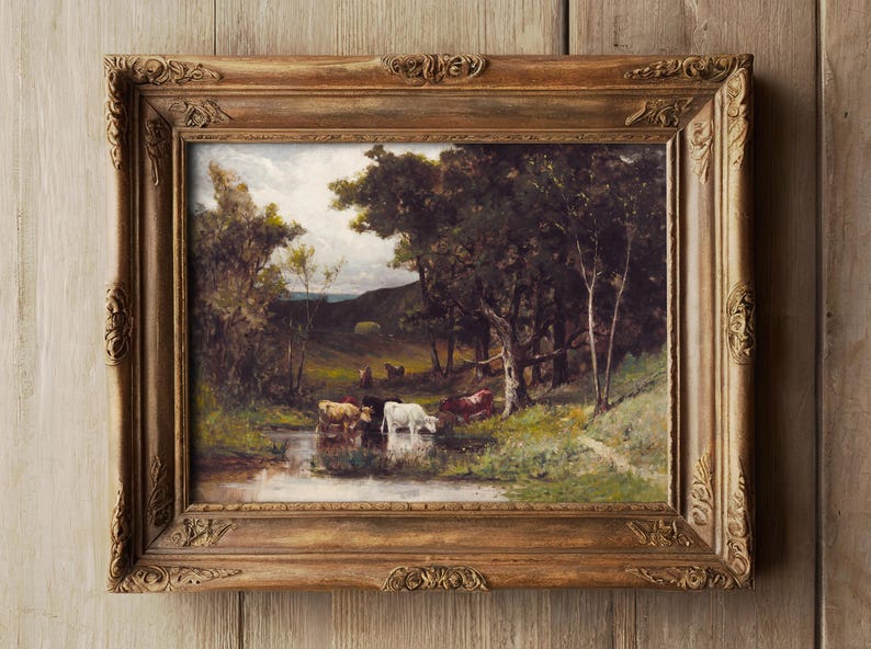 Framed painting of cows by a stream in a lush, green forest under a cloudy sky. The setting is tranquil, with rich, earthy tones and serene atmosphere.