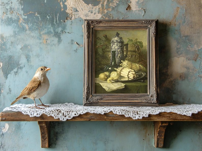 A small bird stands on a lace-covered wooden shelf beside a framed still-life painting. The background has a weathered, textured blue wall, evoking a vintage feel.