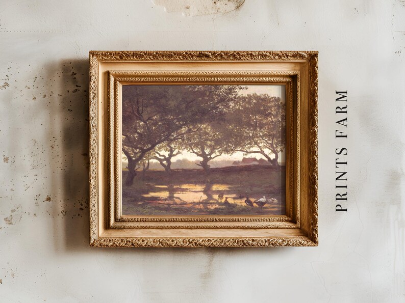 A vintage-style painting in an ornate gold frame hangs on a textured wall. It depicts a serene landscape with trees silhouetted at sunset. The text "PRINTS FARM" is vertically aligned on the right.