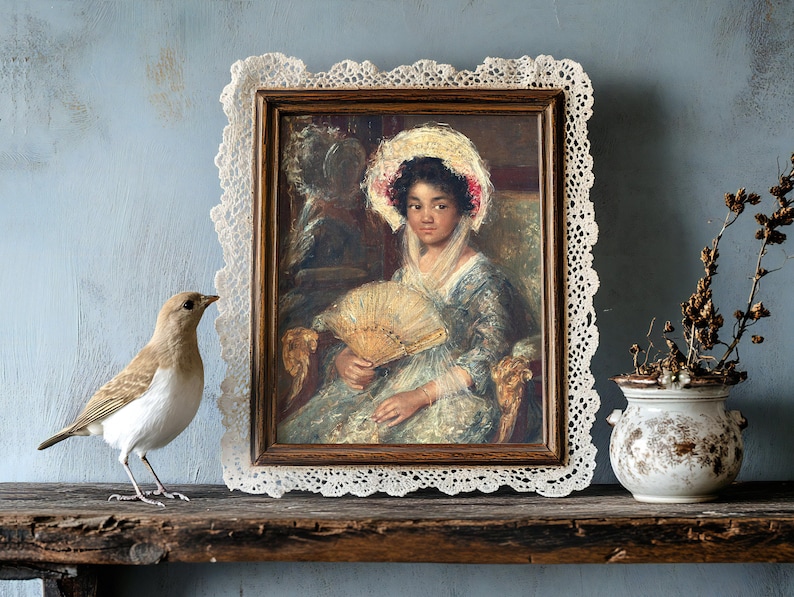 Vintage portrait of a woman with a fan in a lace-trimmed frame on a rustic shelf. A bird and a vase with dried flowers add an antique charm.