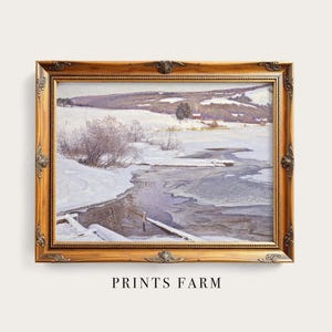 Framed painting of a snowy landscape with a frozen river in the foreground and distant hills. Sparse trees accent the serene winter scene.