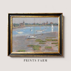 A framed oil painting depicting a seascape with sailboats anchored in a harbor. The painting features a light blue sky, a calm body of water, and a distant shoreline with buildings. The sailboats are white and have various sizes and shapes.