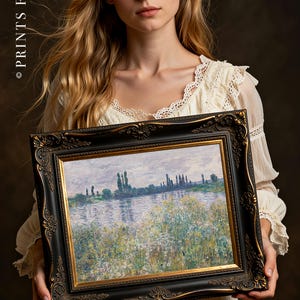 Woman in a white dress holds a framed painting of a serene riverside landscape with trees and wildflowers, evoking a calm and reflective mood.