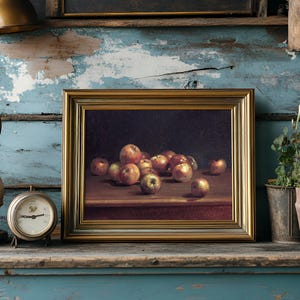 Framed painting of apples on a shelf, flanked by a vintage clock and vase against a rustic blue distressed wall, conveying a nostalgic vibe.