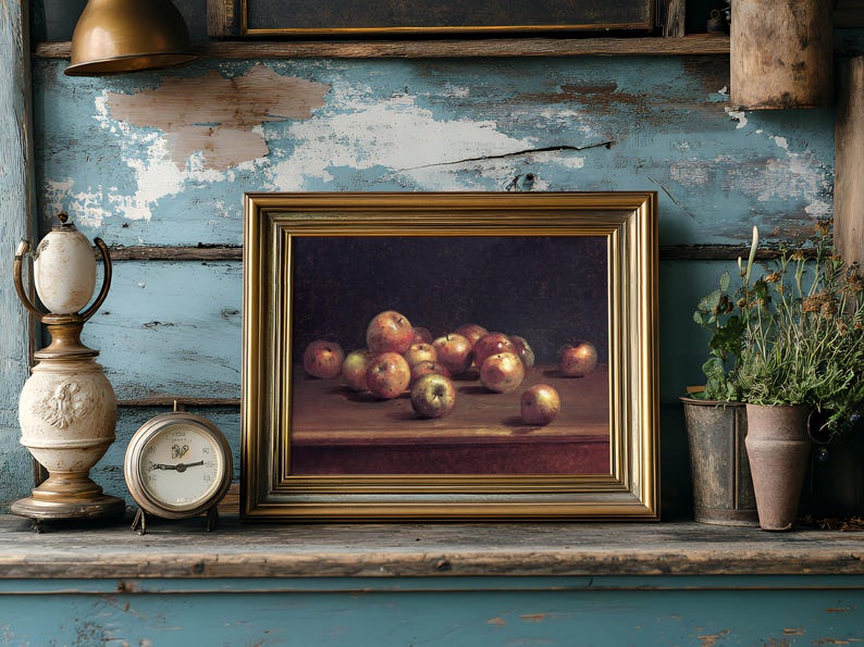 Framed painting of apples on a shelf, flanked by a vintage clock and vase against a rustic blue distressed wall, conveying a nostalgic vibe.