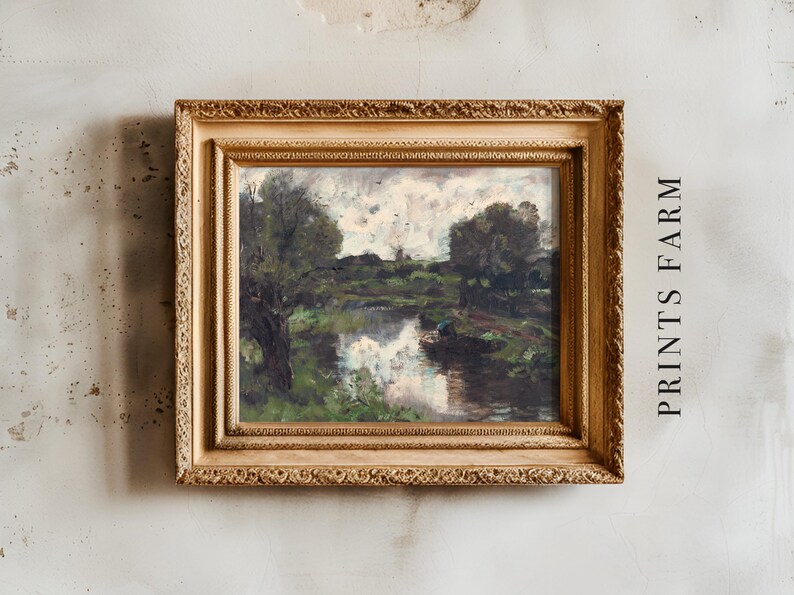 Ornate gold-framed painting of a serene river landscape with reflections, overcast sky, and lush greenery. Text reads "PRINTS FARM" on a textured wall.