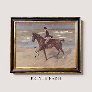 Framed painting of a rider on horseback with a dog on a beach. The scene is serene, with soft colors and gentle waves. Text reads "Prints Farm."