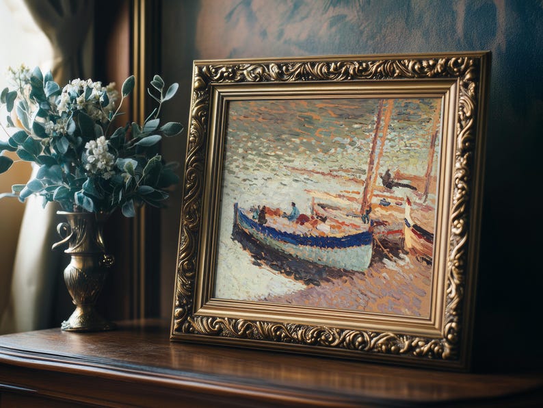 A framed impressionist painting of boats on water, richly textured with soft brushstrokes. Beside it is a vase of white flowers on a wooden table.