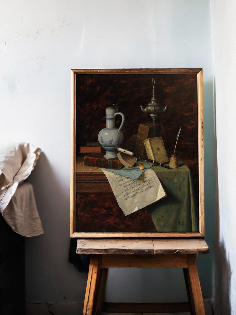 A framed still life painting on an easel shows a jug, books, sheet music, and a musical instrument on a draped table, evoking a classic, serene mood.
