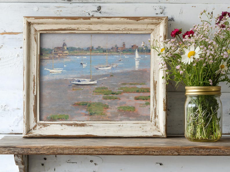 A rustic, framed painting of boats on a serene lake rests on a wooden shelf. Beside it, a mason jar holds colorful wildflowers, creating a calm, nostalgic tone.