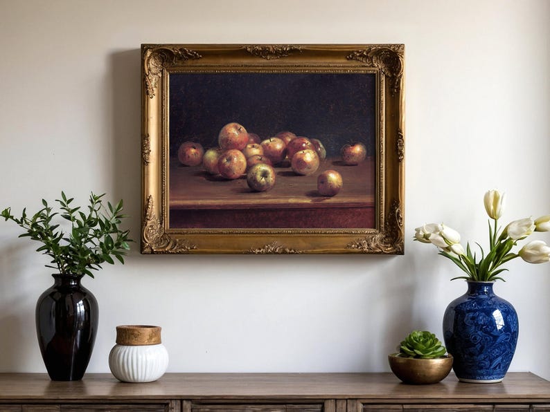 A classic still-life painting of apples in a gold frame hangs above a wooden console. Vases with greenery and white flowers adorn the console, creating a serene ambiance.